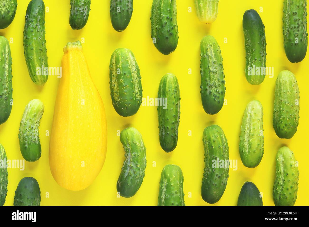 Freshly picked vegetables, zucchini and cucumbers on a yellow background, top view Stock Photo
