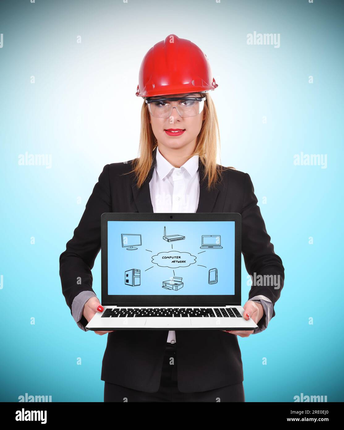woman engineer holding laptop with computer network Stock Photo