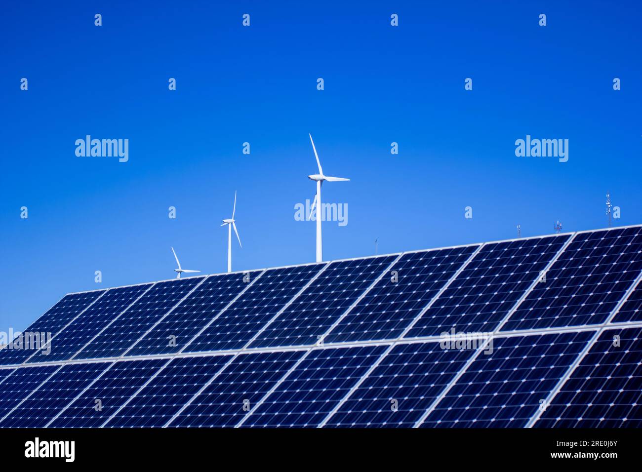 Solar panels and wind turbines with blue sky background Stock Photo - Alamy