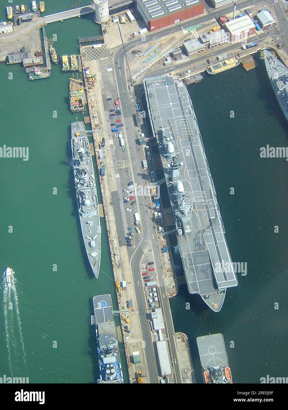 Aerial view looking down on His Majesty's Naval Base, Portsmouth (HMNB Portsmouth) with warships and HMS Ark Royal aircraft carrier. Stock Photo