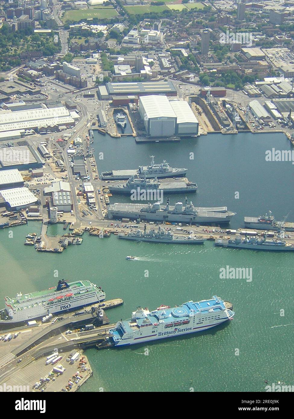 Aerial view looking down on His Majesty's Naval Base, Portsmouth (HMNB Portsmouth) with warships and HMS Ark Royal aircraft carrier, and ferries Stock Photo