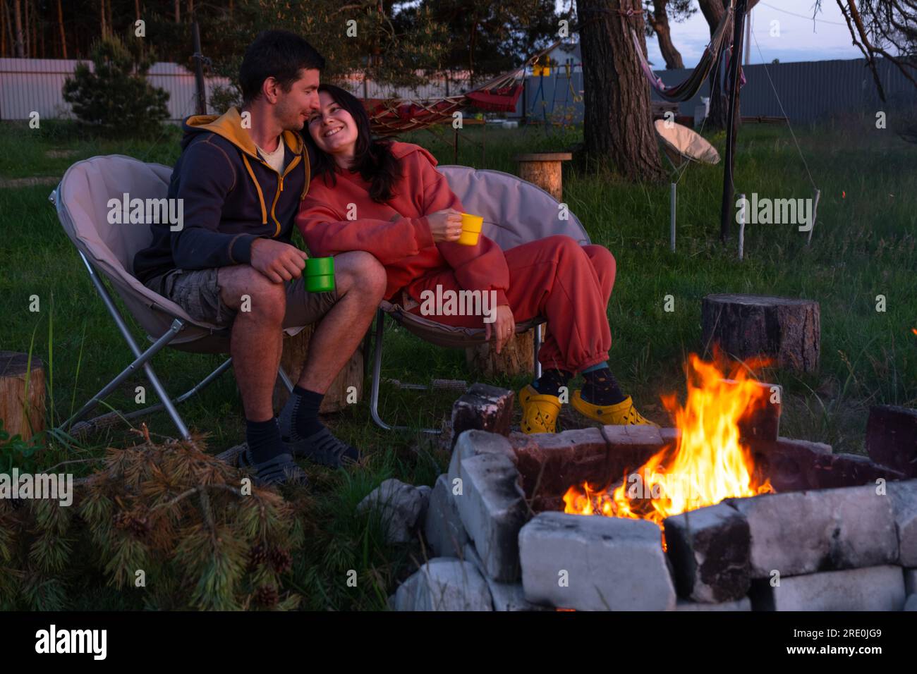 Couple sitting on camping chairs hi-res stock photography and images ...