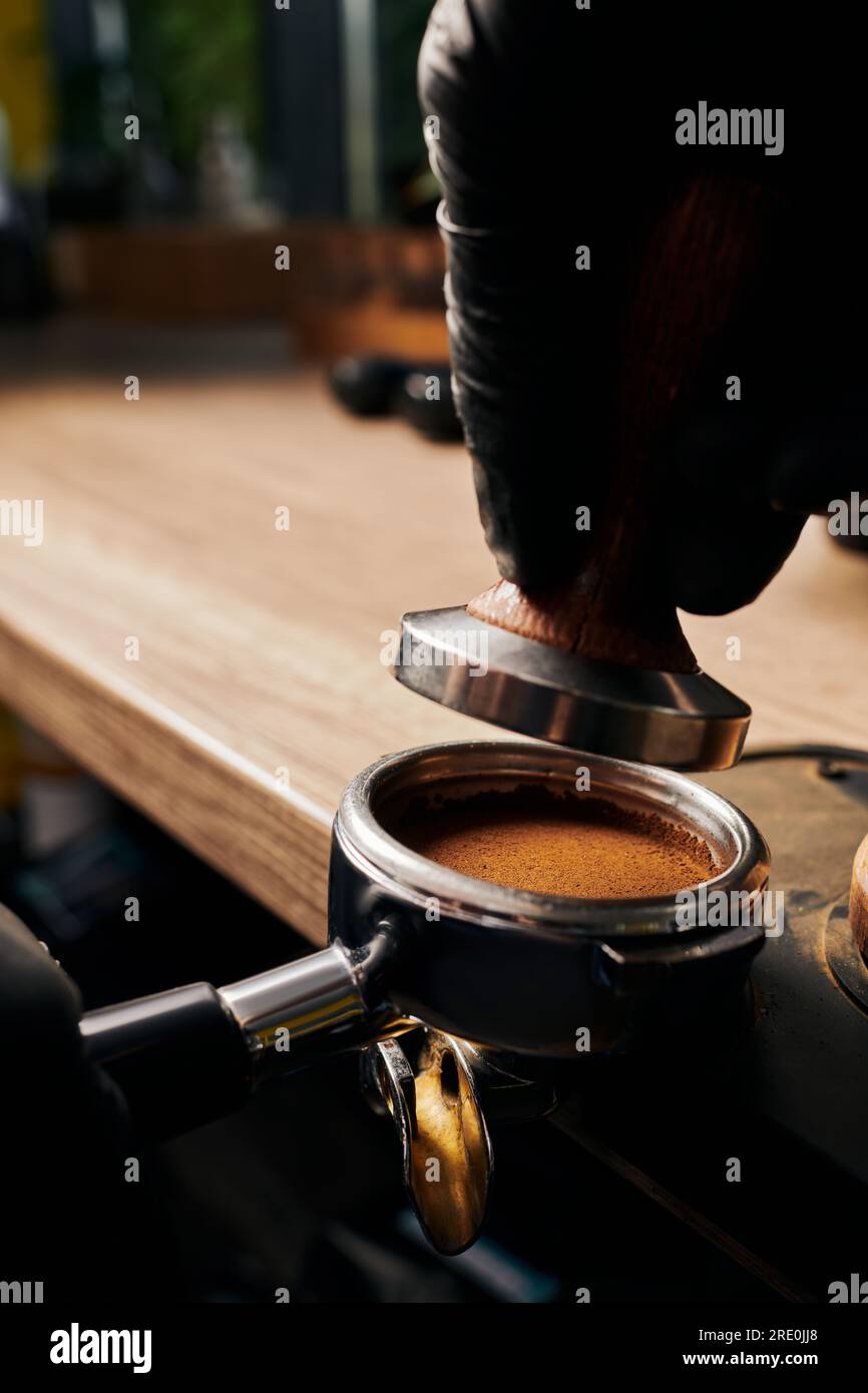 barista holding portafilter with grinded coffee, tamper, cafe, alternative  brew, top view Stock Photo by LightFieldStudios