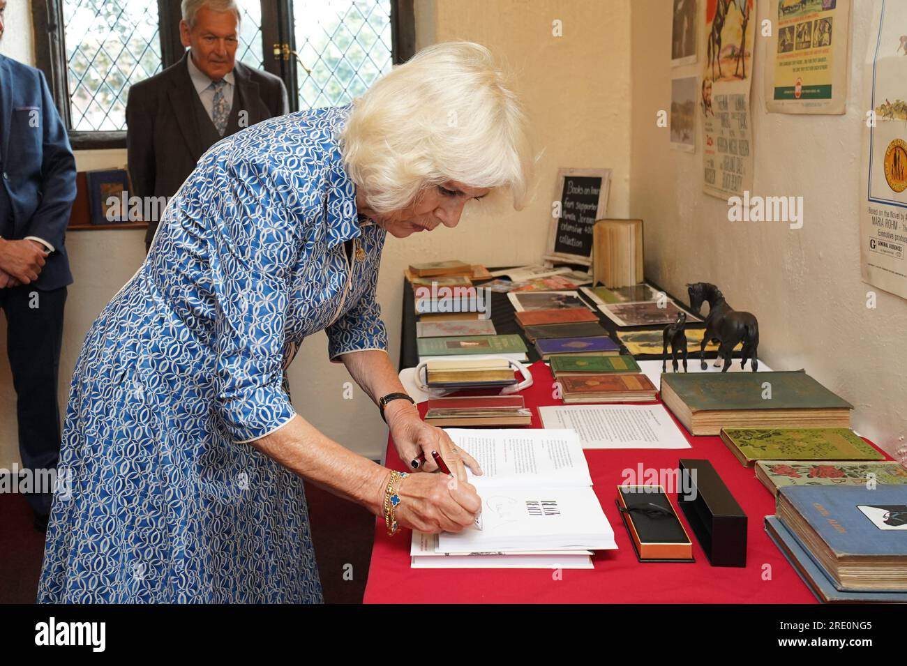 Queen Camilla signing a copy of Black Beauty during a visit to Redwings Horse Sanctuary at Anna Sewell House in Great Yarmouth, while on a visit to Norfolk. Redwings Horse Sanctuary have been the custodians of Anna Sewell House since 2022. The House is the verified birthplace of Anna Sewell, author of Black Beauty. Picture date: Monday July 24, 2023. Stock Photo