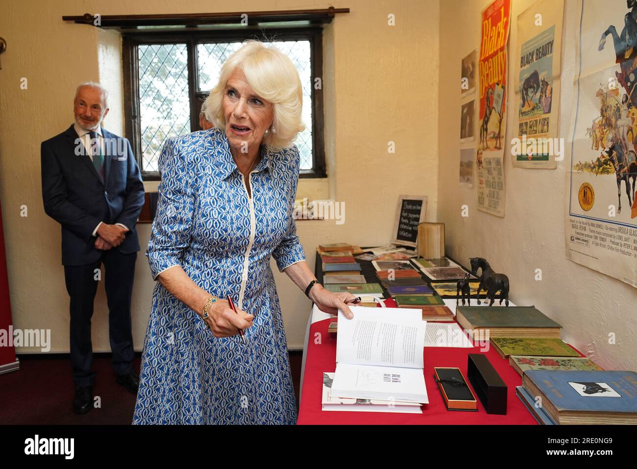 Queen Camilla signing a copy of Black Beauty during a visit to Redwings Horse Sanctuary at Anna Sewell House in Great Yarmouth, while on a visit to Norfolk. Redwings Horse Sanctuary have been the custodians of Anna Sewell House since 2022. The House is the verified birthplace of Anna Sewell, author of Black Beauty. Picture date: Monday July 24, 2023. Stock Photo
