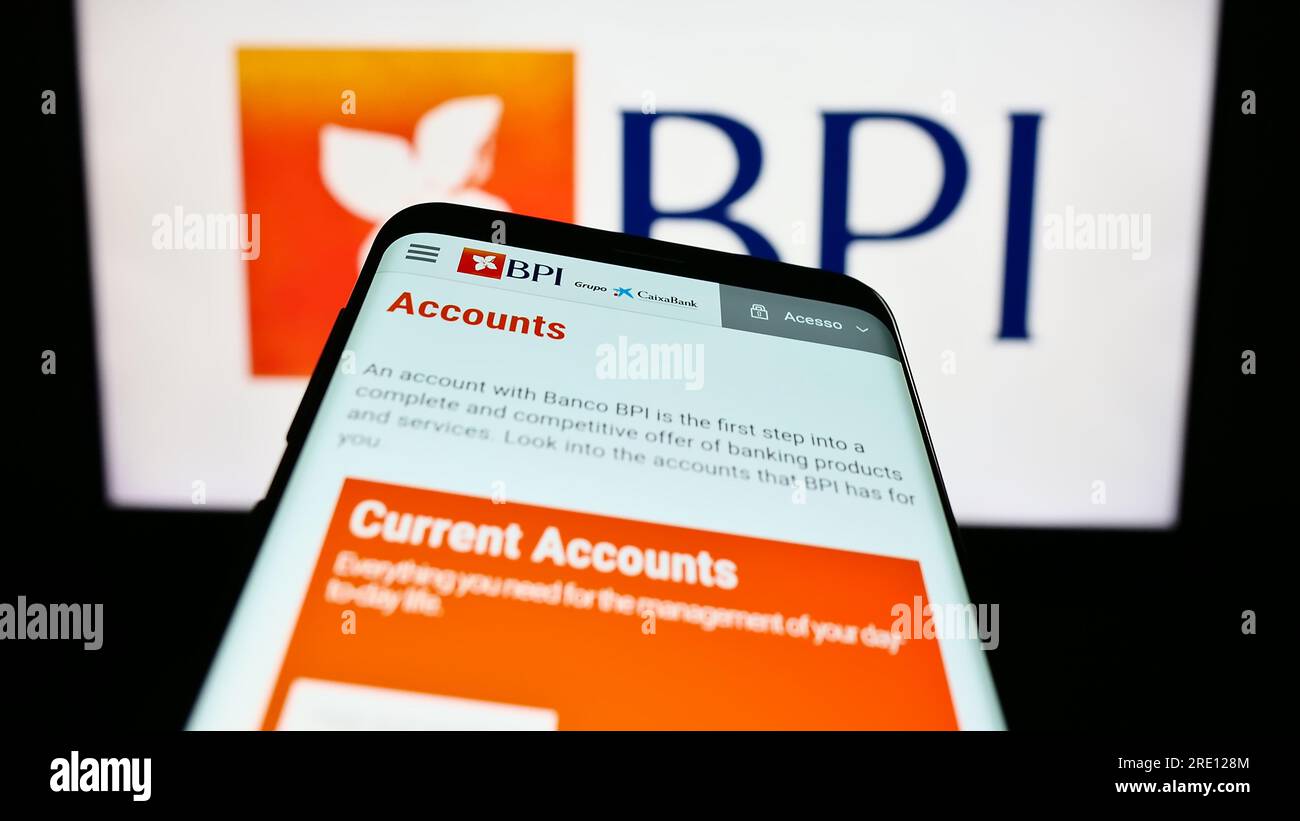 Smartphone with website of Banco Portugues de Investimento S.A. (BPI) on screen in front of business logo. Focus on top-left of phone display. Stock Photo