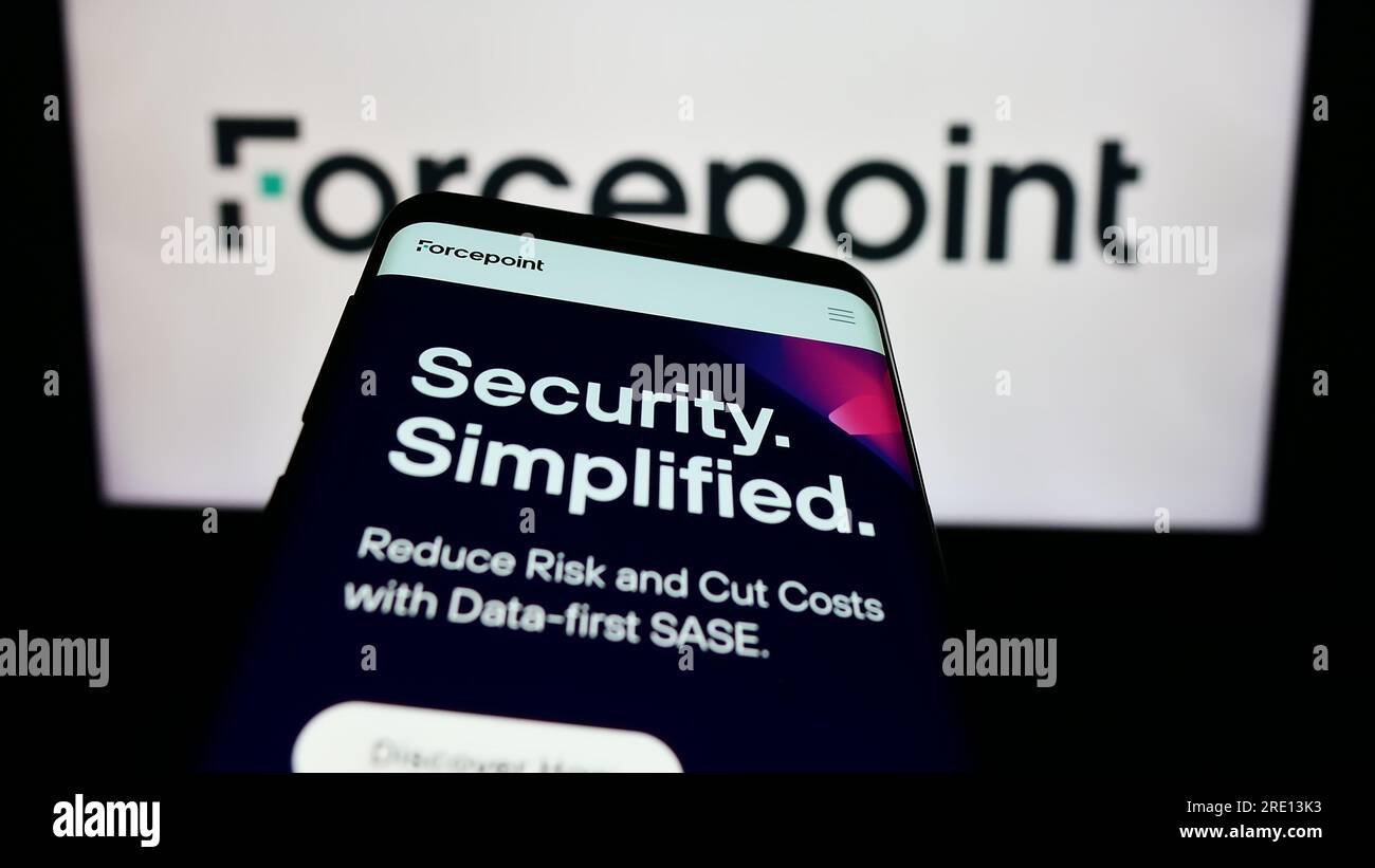 Mobile phone with website of US cybersecurity company Forcepoint LLC on screen in front of business logo. Focus on top-left of phone display. Stock Photo