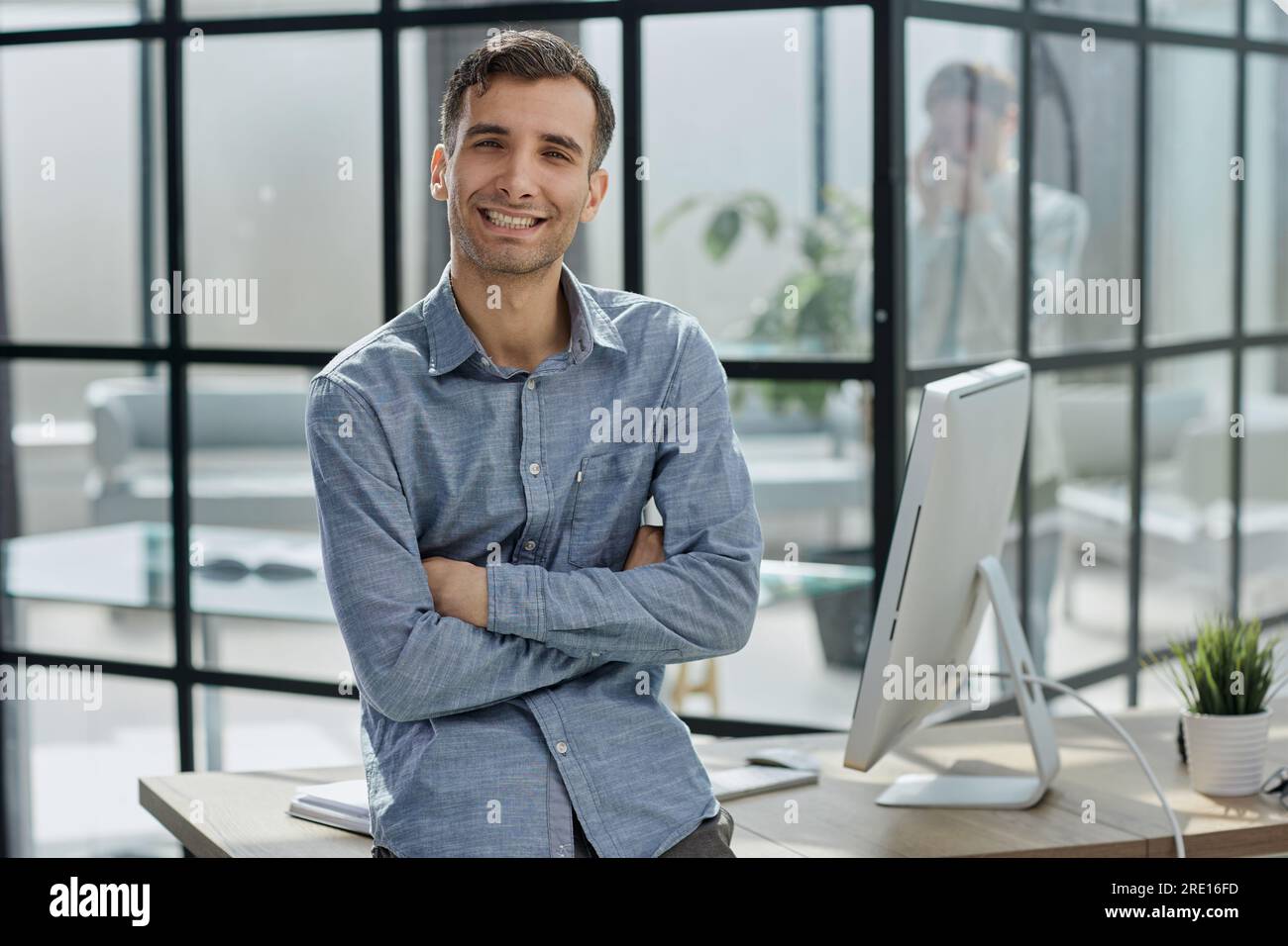 young businessman in the office with his arms crossed Stock Photo - Alamy