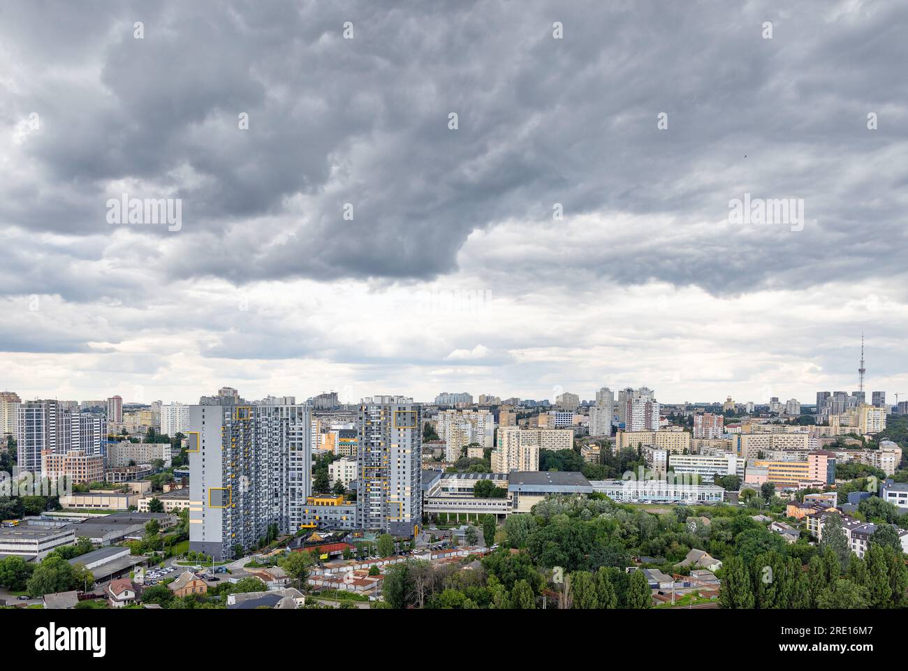 Aerial view, rain gray clouds gather over high-rise residential buildings in the city. Copy space. Stock Photo