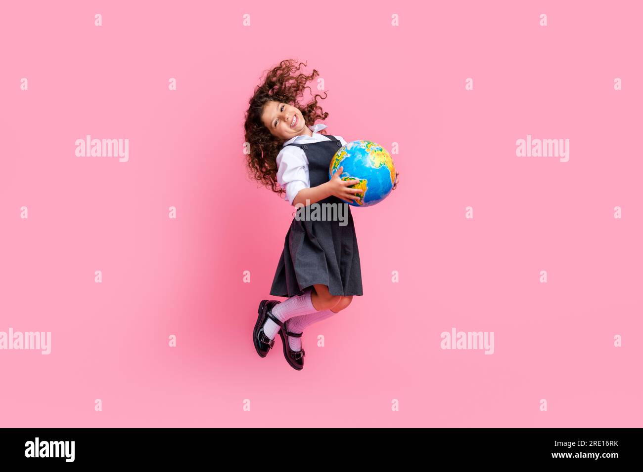 Full length photo of excited cheerful girl jumping hands hold planet ...