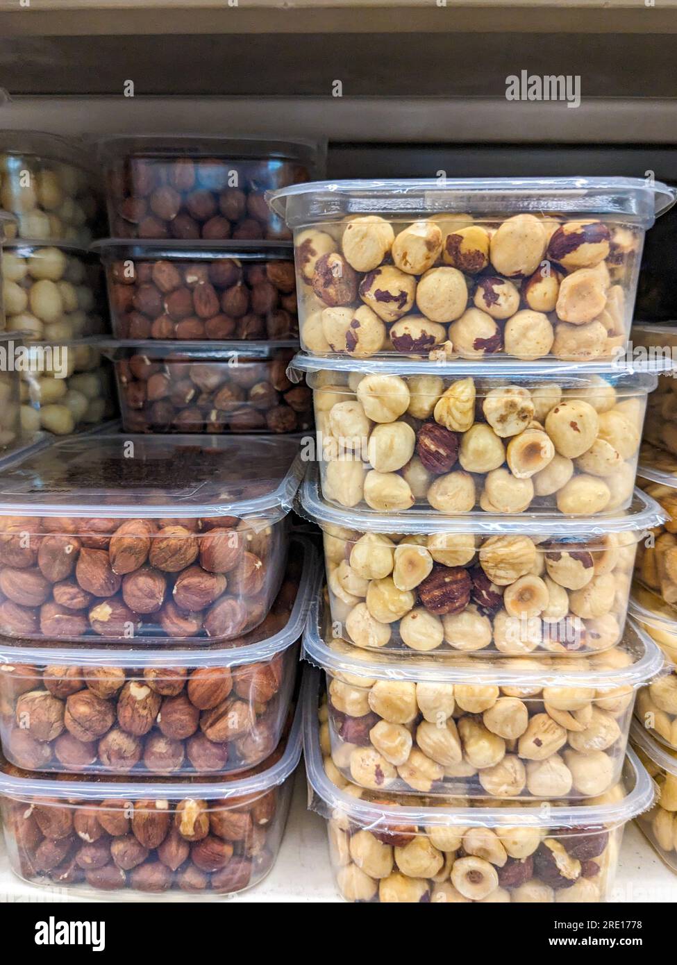 Peeled and unpeeled hazelnuts in plastic packages in the supermarket ...