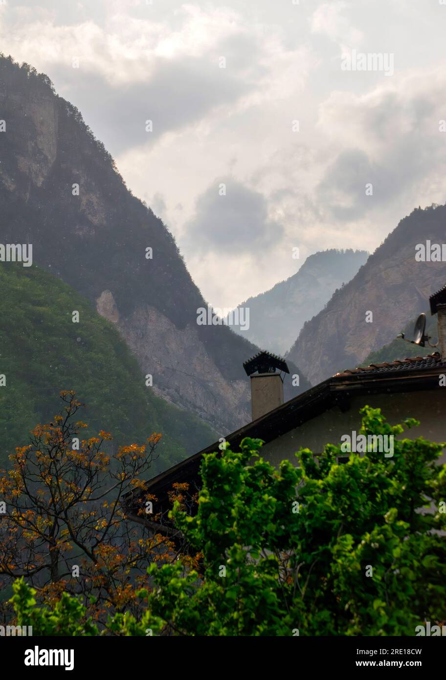 Mountain peaks and clouds over the village of Margreid, South Tyrol, Italy Stock Photo