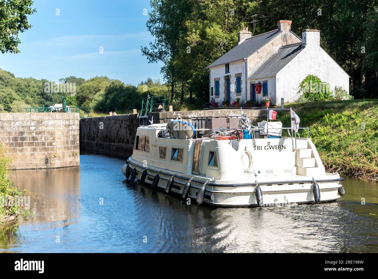 Boat passing the Minazen Lock on the Blavet river in Languidic