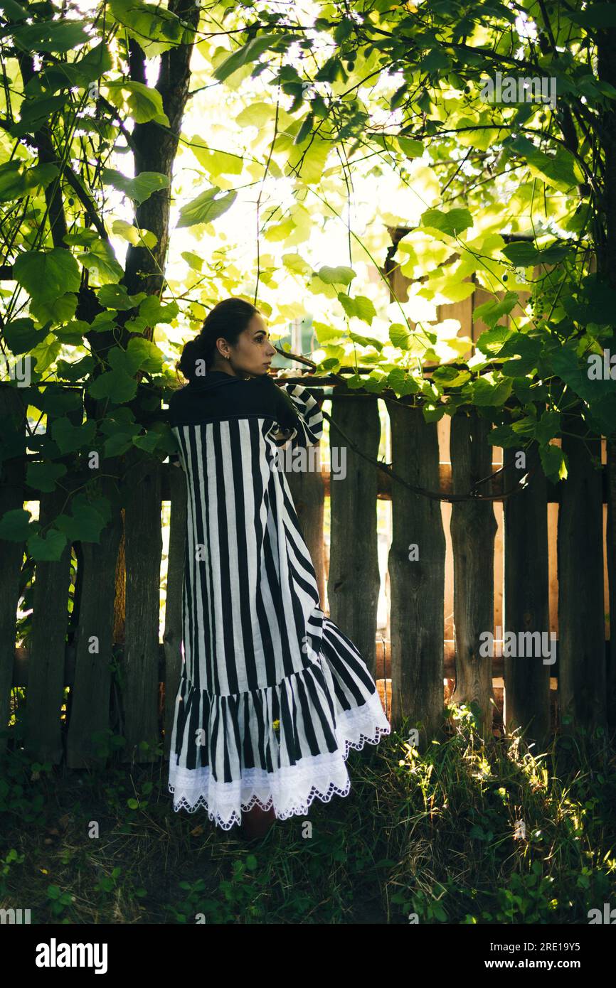 Stylish young indian woman in black and white dress on a