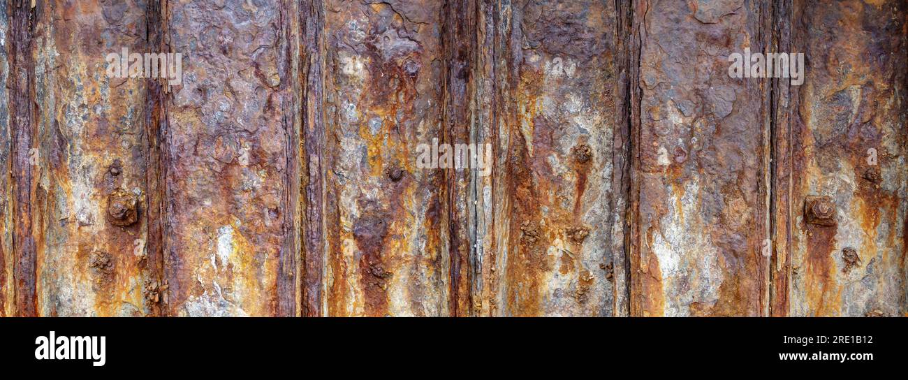 A section of heavily rusted and corroded iron breakwater Stock Photo