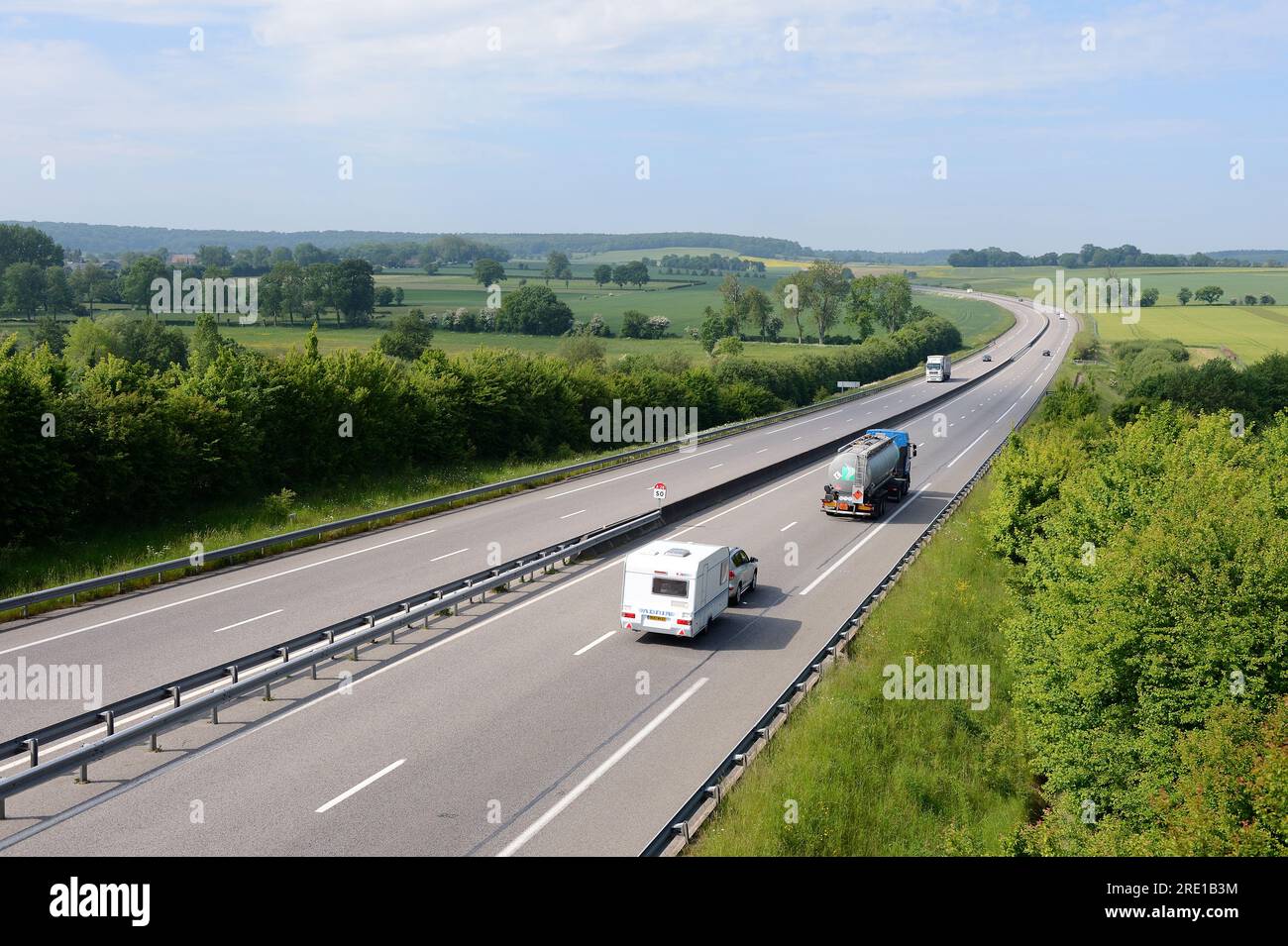 Highway A28 crossing the “pays de Bray” area. Car towing a trailer and tank truck Stock Photo