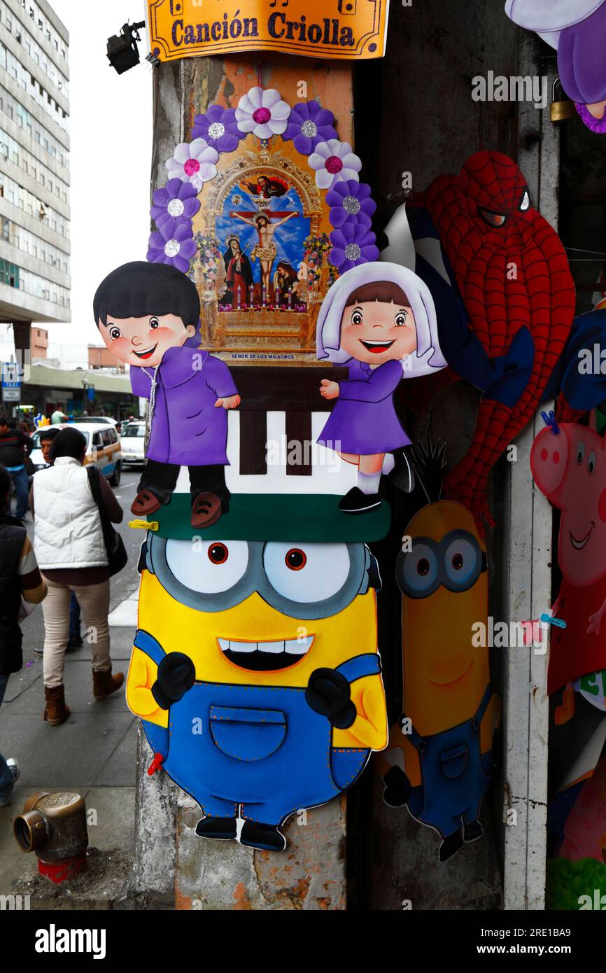 Lord of Miracles / Señor de los Milagros picture and Minions characters outside shop selling things for children's parties in central Lima, Peru Stock Photo