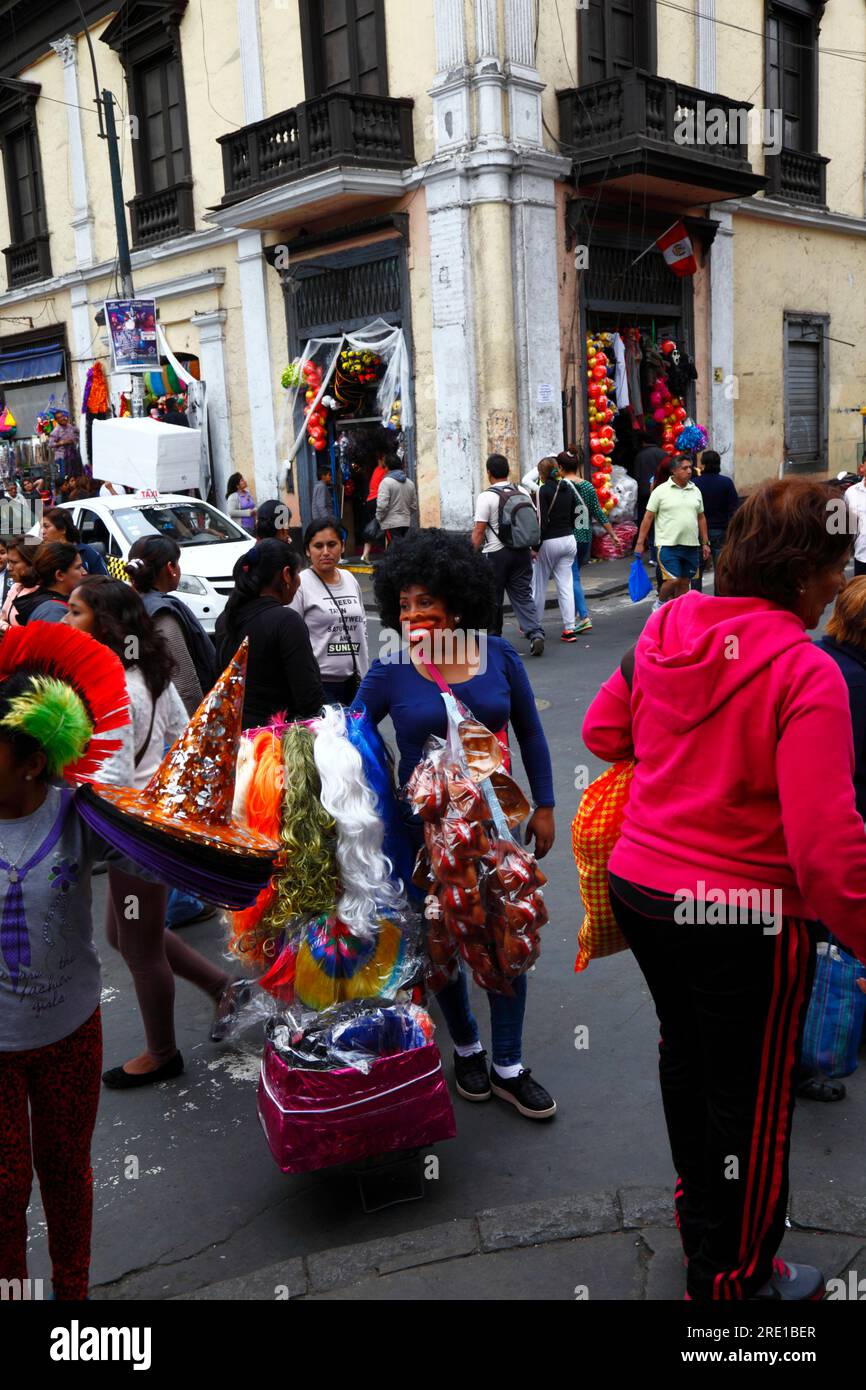 Woman wearing an afro wig and rubber face mask with big red lips