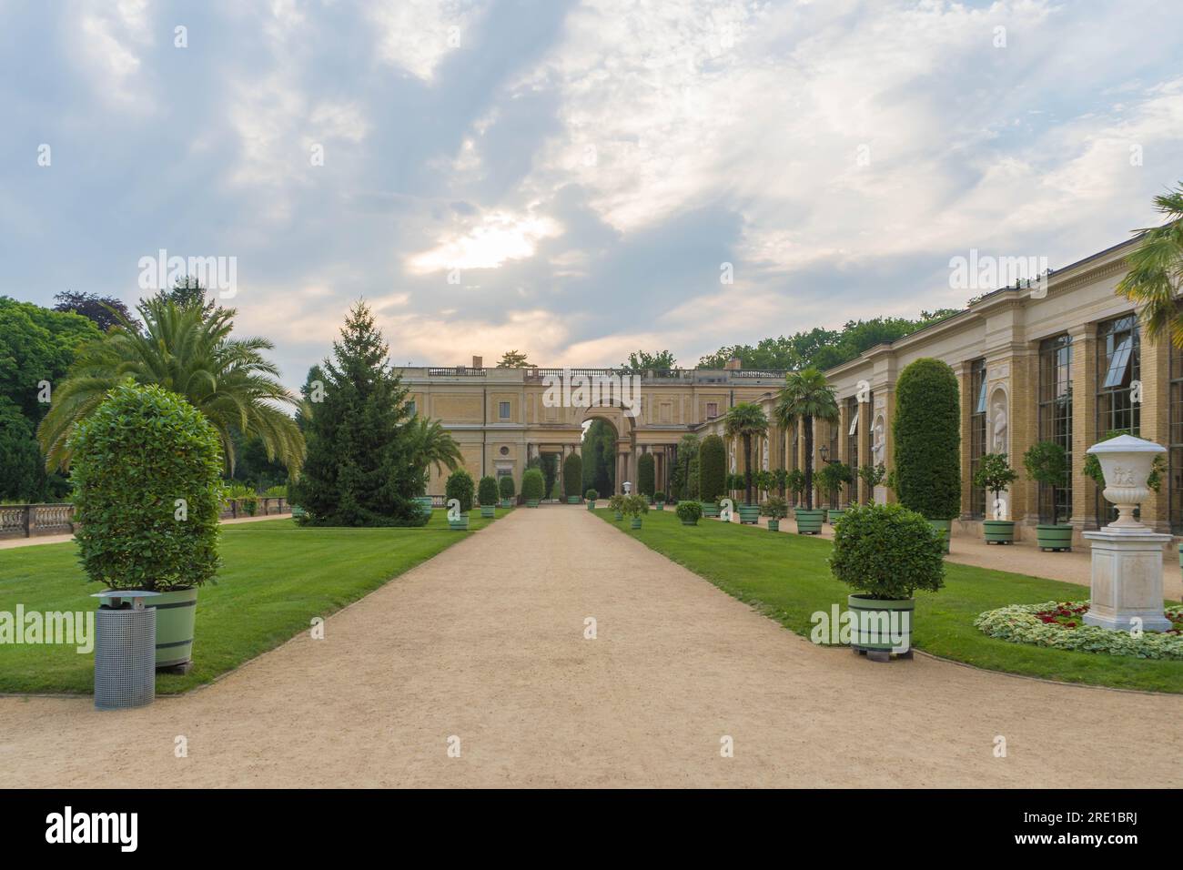 Potsdam, Germany. 24 July 2021. Historical Orangery Palace in Potsdam, Germany, amidst lush Palms in Potsdam's Sanssouci Park on a Glorious Afternoon Stock Photo