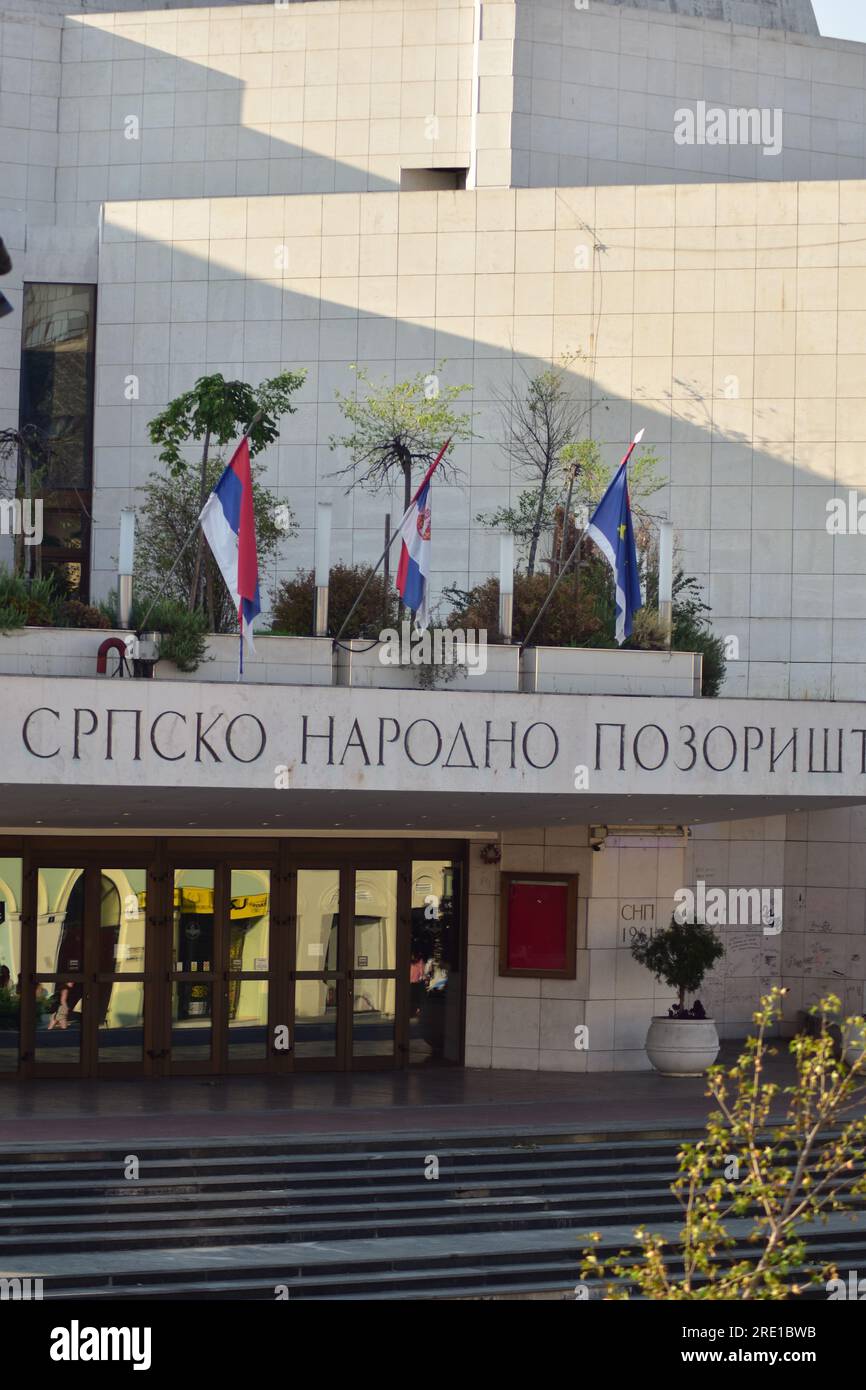 Flags of Serbia, Vojvodina and Novi Sad on a Serbian national theater on a sunny day Stock Photo