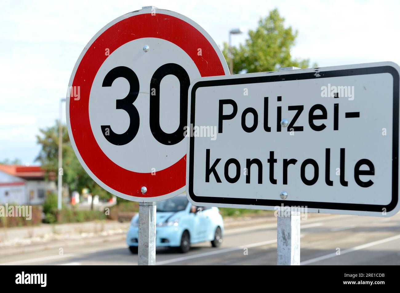 Police check by German police officers (Polizei) at the French German border for vehicles entering Germany. 30km/h speed limit sign, Rheinau, Germany. Stock Photo