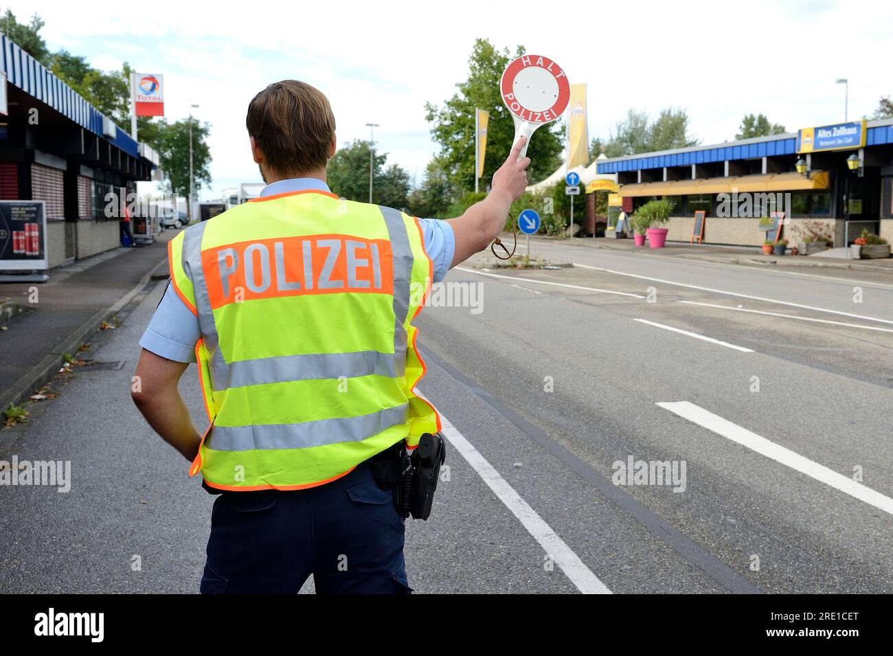 Police check by German police officers (Polizei) at the French German border, in Rheinau, for vehicles entering Germany. Police officer viewed fro beh Stock Photo