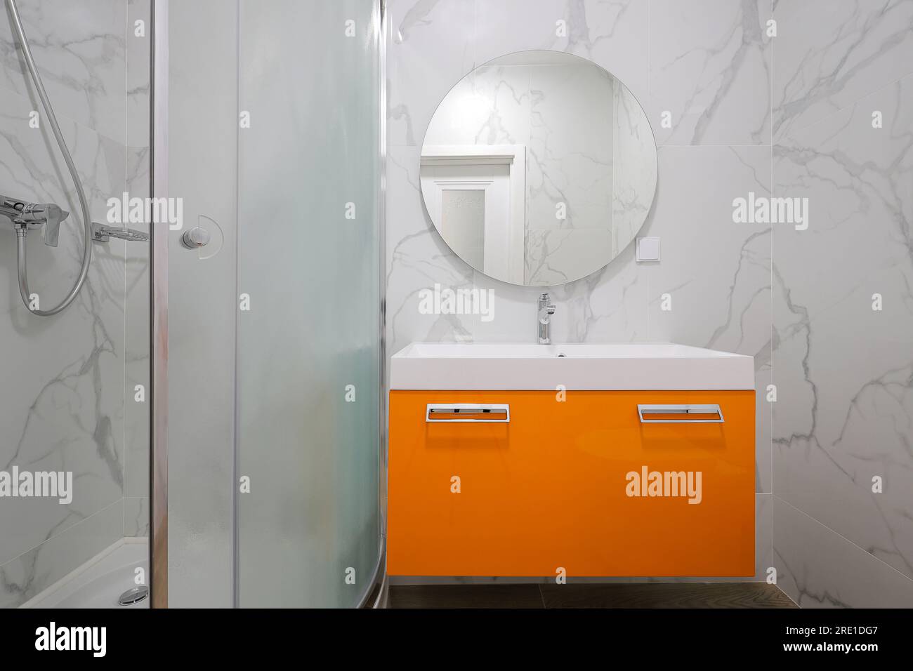 Bathroom furniture with white sink and round mirror Stock Photo Alamy