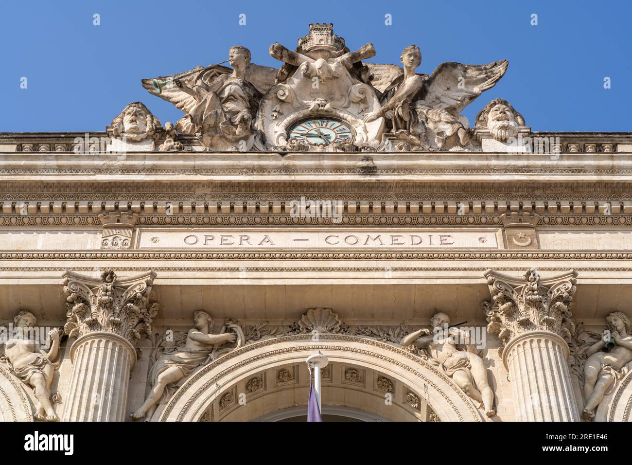 Montpellier, France - 07 23 2023 : Low angle detail view of the historic stone facade and carved pediment of landmark Opera Comedie theater Stock Photo