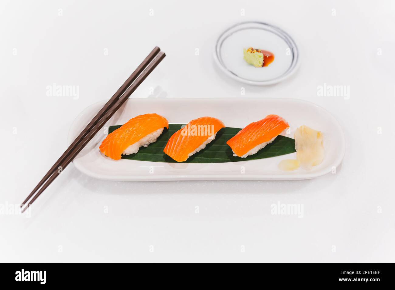 Salmon shushi roll and wasabi shoyu sauce with chopsticks Stock Photo