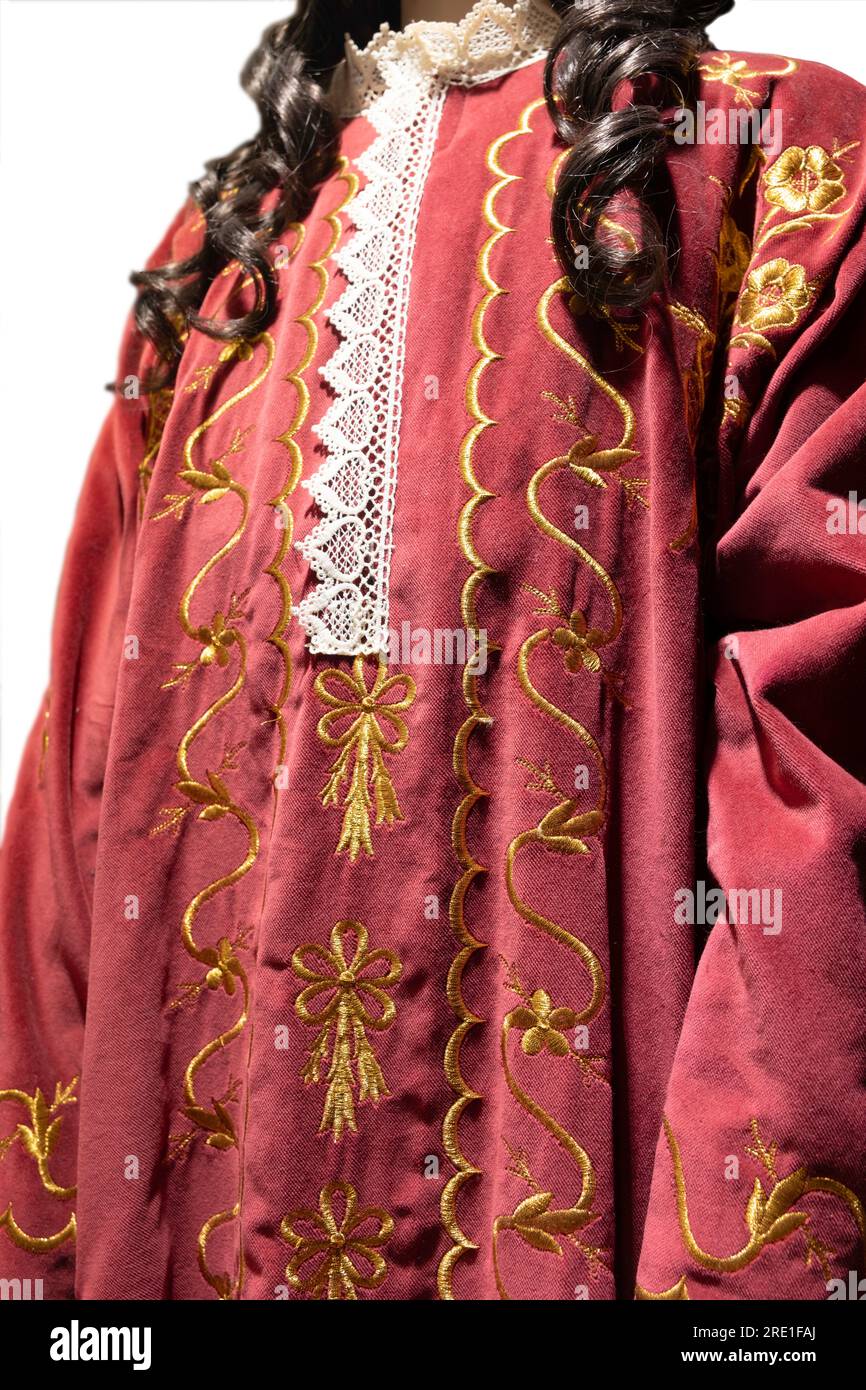 Cloak of red cloth with gold-coloured stitching. Trakai Castle and Museum in Trakai, Lithuania. Exhibition of historical clothing Stock Photo