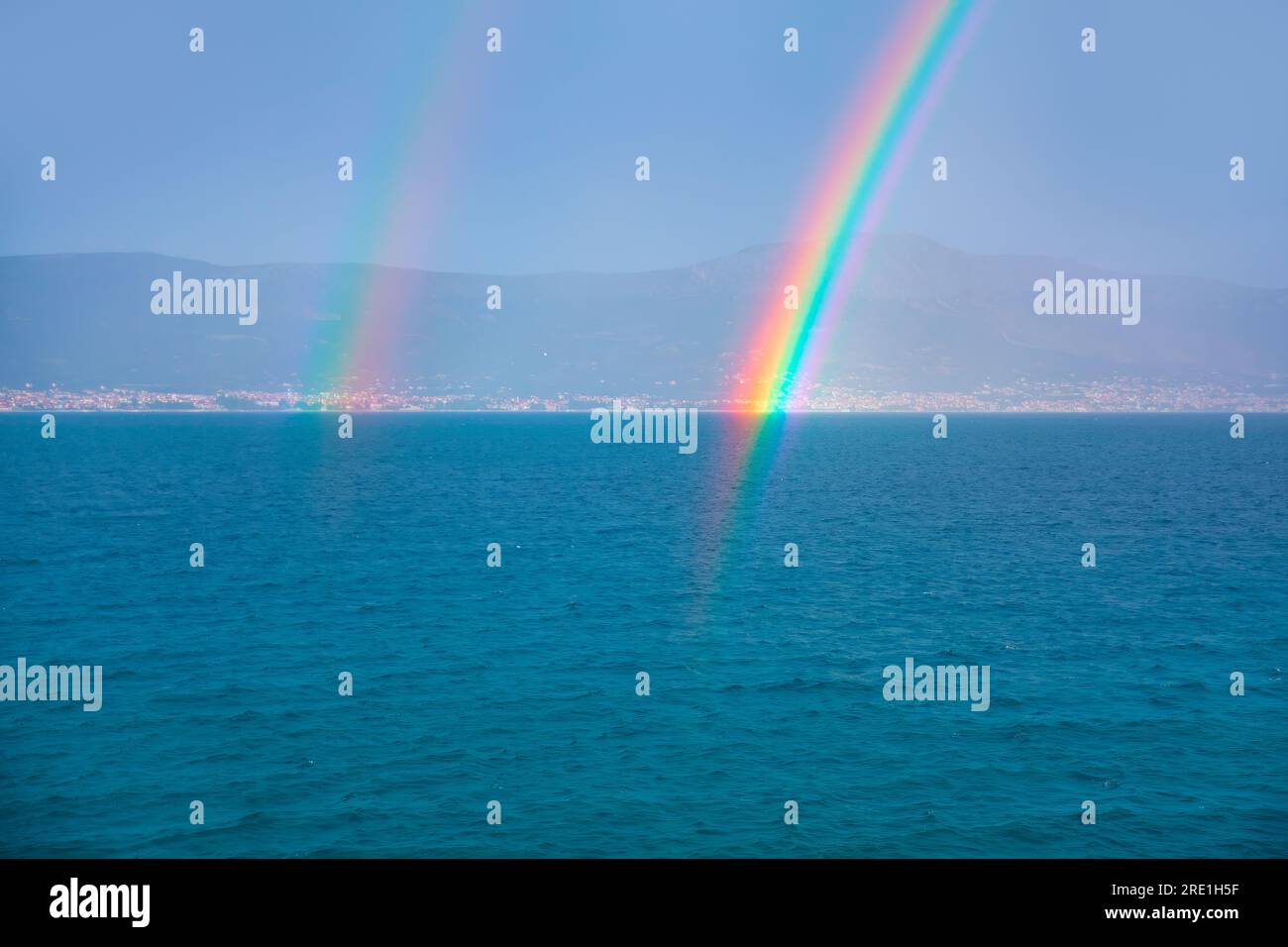 Two rainbows over the sea . Colorful natural phenomenon Stock Photo - Alamy
