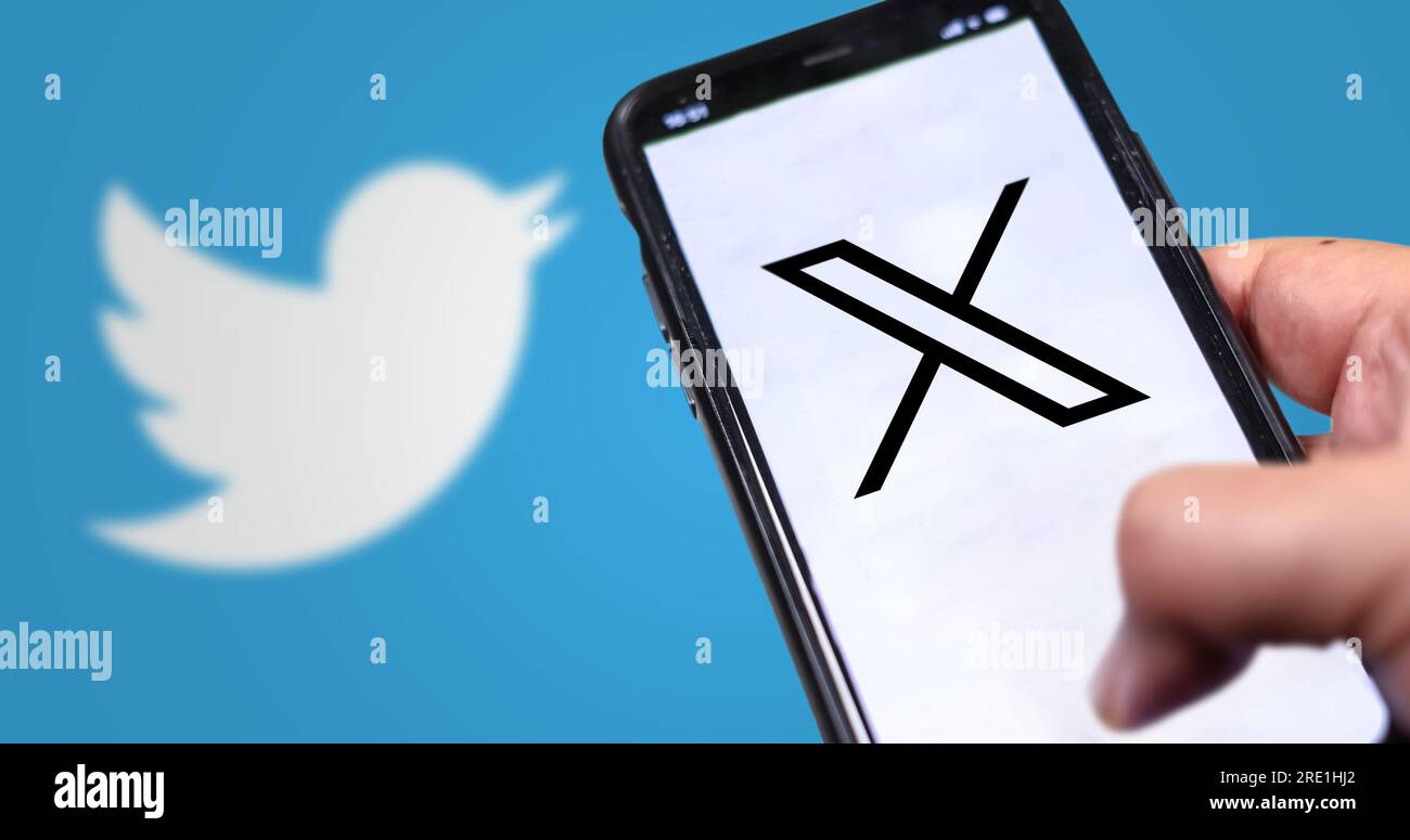 San Francisco, US, July 23 2023: hand holding a mobile phone with the new X logo on the screen. On July 24, 2023, Twitter changed its logo from the bl Stock Photo