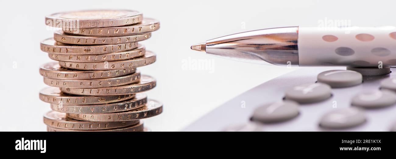 business, finance and economy with pencil, coins and calculator Stock Photo