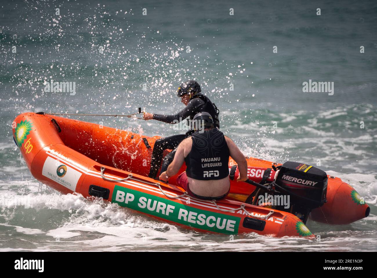 Two surf life savers patrol Paunanui Beach in a small RIB safety boat