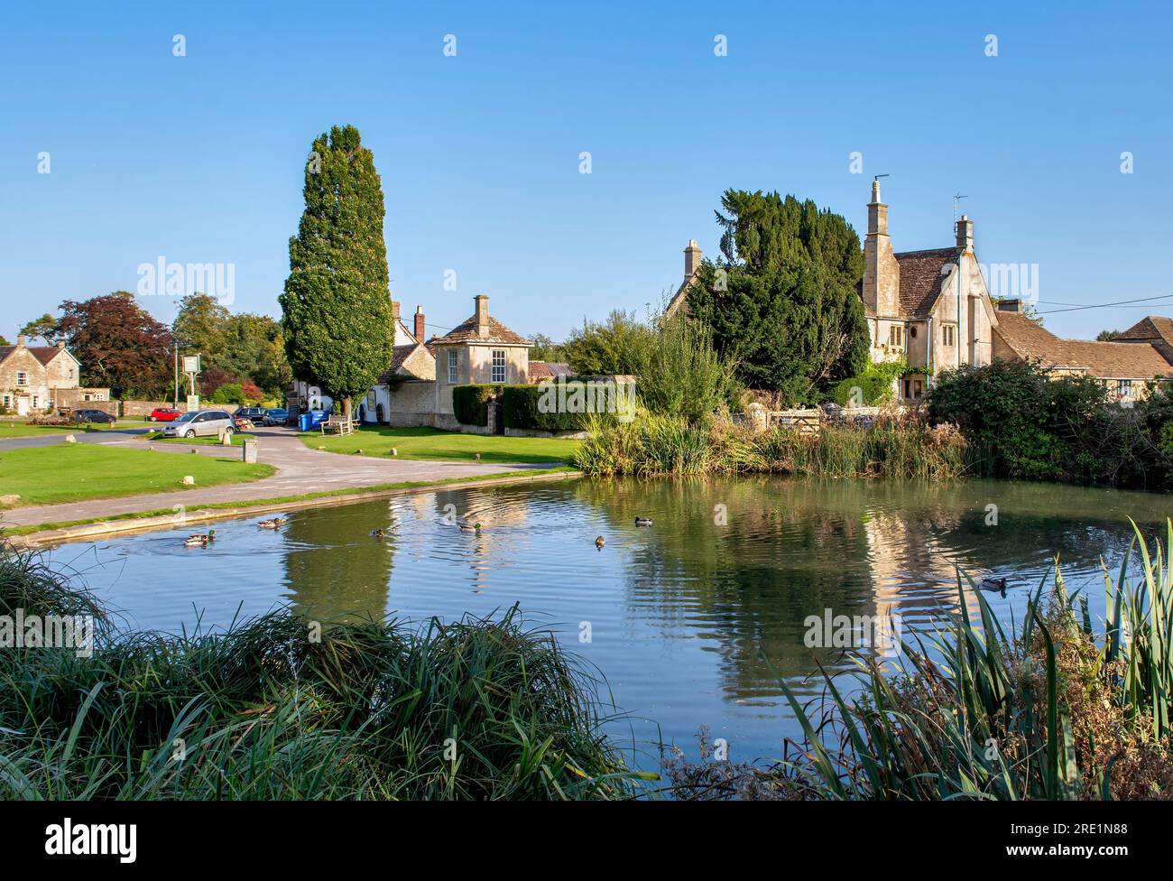 The picturesque village of Biddestone and duck pond in the Cotswolds, England in summer where Agatha Raisin was filmed Stock Photo