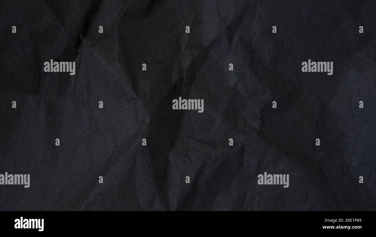 Dark abstract textile background texture. Black crumbled paper texture. Stock Photo