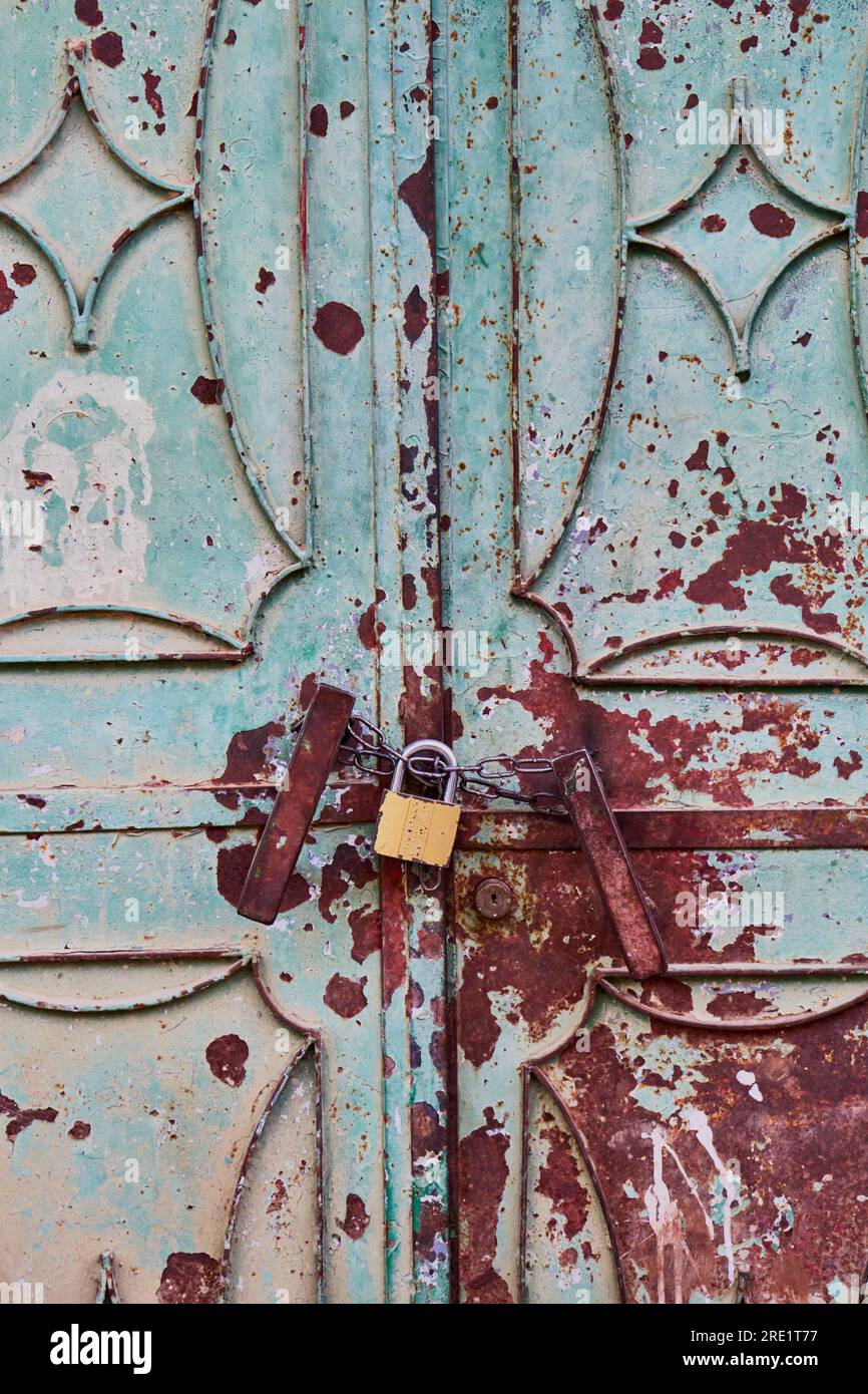 Rusty metallic door with a padlock Stock Photo