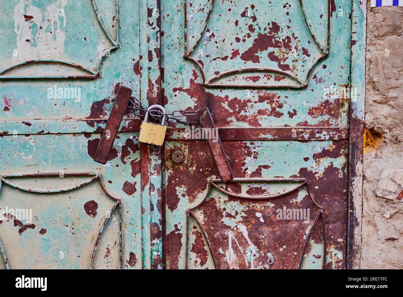 Rusty metallic door with a padlock Stock Photo