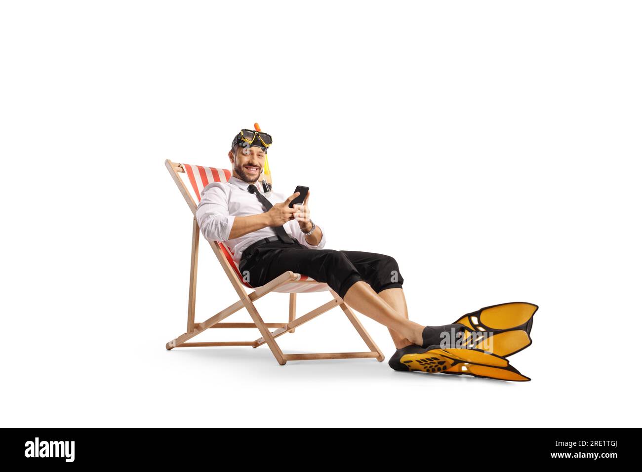 Businessman sitting on a beach chair with a snorkel mask and fins and holding a smartphone isolated on white background Stock Photo
