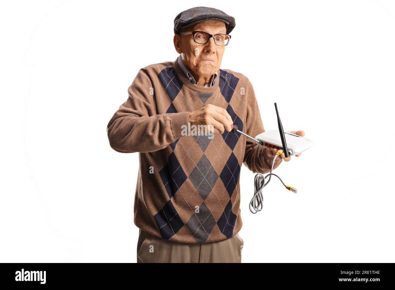 Funny old man trying to fix router with a screwdriver isolated on white background Stock Photo