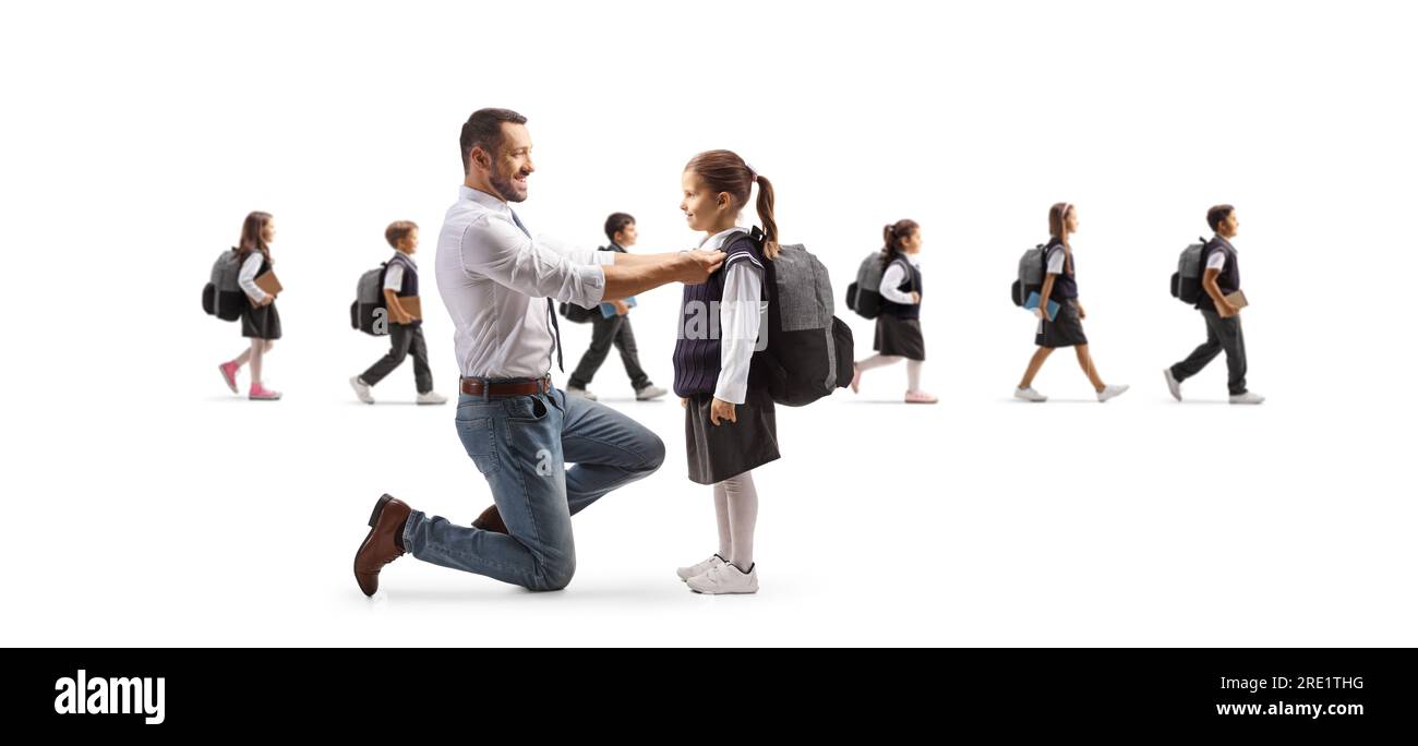 Father helping daughter getting ready for school and other children walking in the back isolated on white background Stock Photo