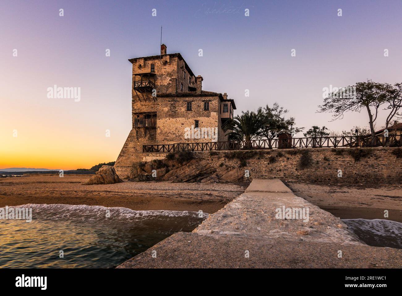 Beautiful old tower in greece, the historic stone tower, was a weir tower in ouranoupoli by the sea Stock Photo