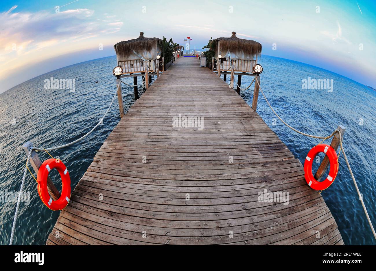 Pavilions on the pier by the sea. Evening atmosphere. Fish Eye Effect. Stock Photo