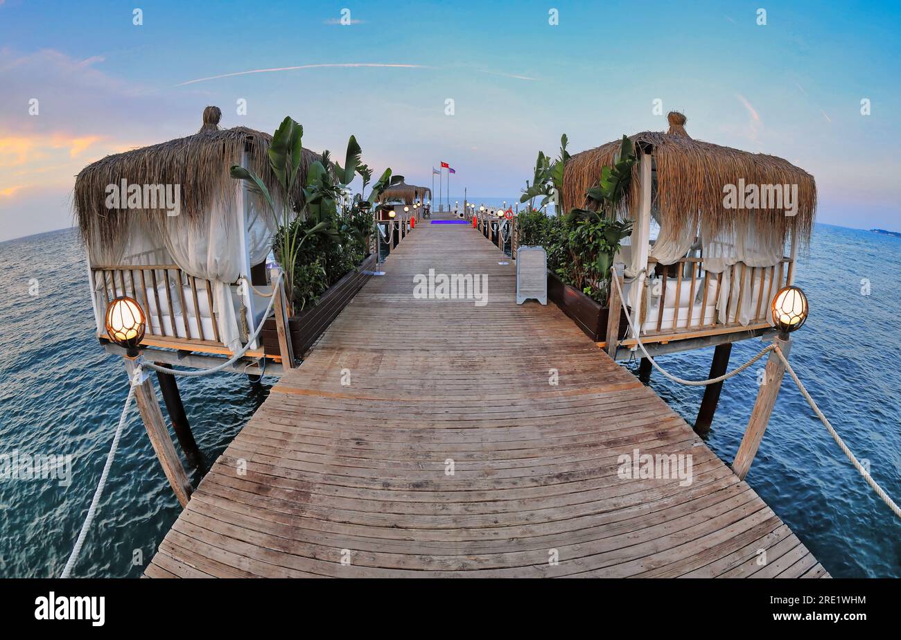 Pavilions on the pier by the sea. Evening atmosphere. Fish Eye Effect. Stock Photo