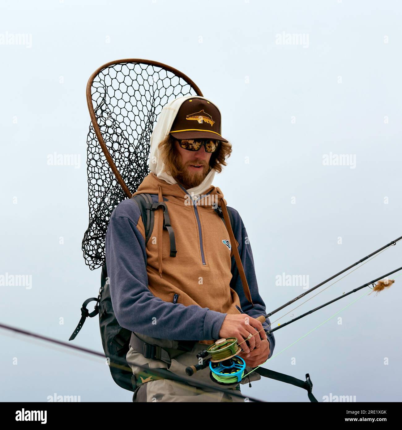Man walking to river to go fly fishing Stock Photo Alamy