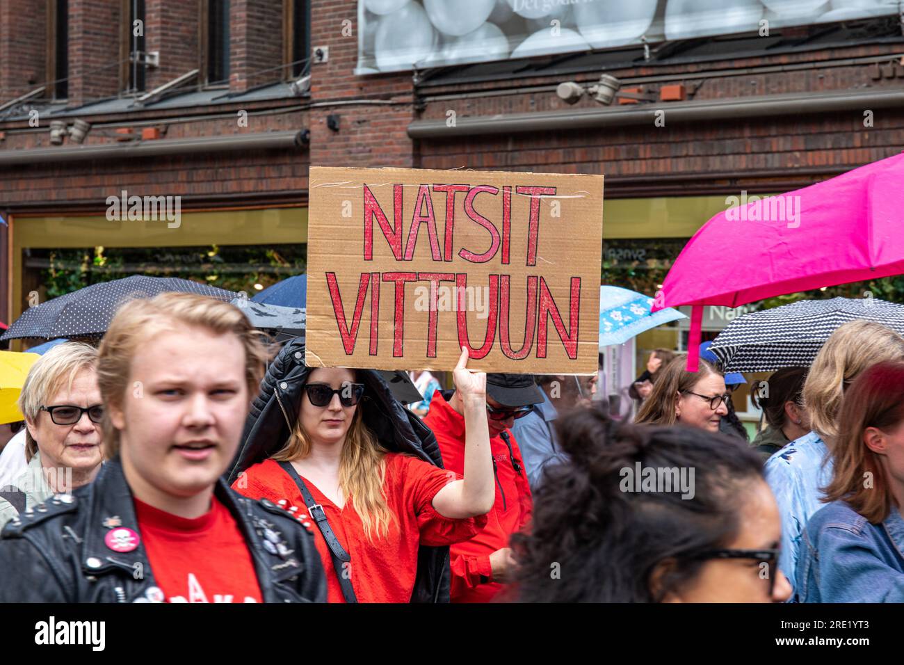 Natsit vittuun. Protester holding a handmade cardboard sign at Nollatoleranssi! demonstration agains far-right politics in Helsinki, Finland. Stock Photo