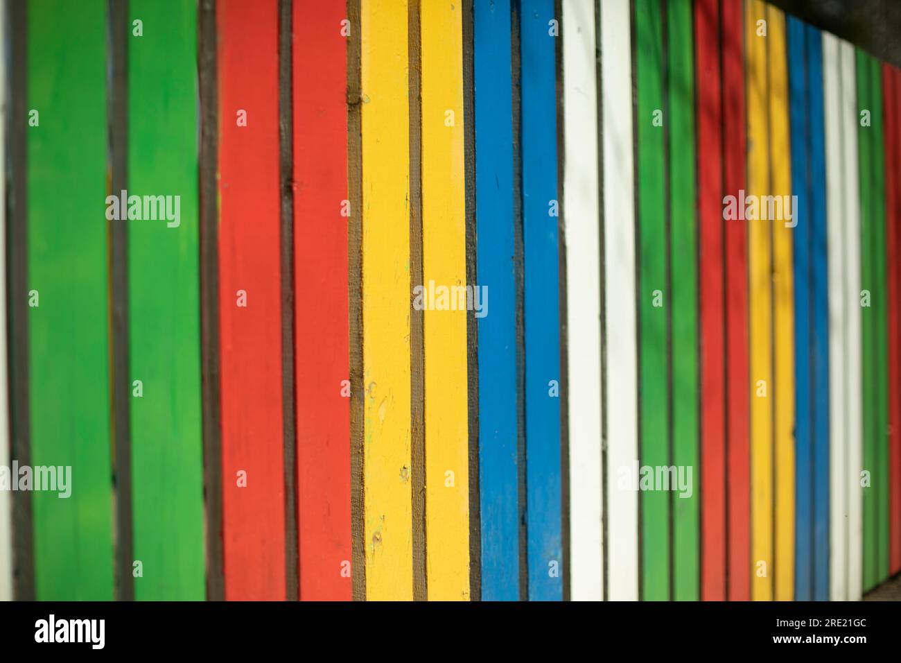 Colored fence. Beautiful fence. Different color on boards. Painted ...