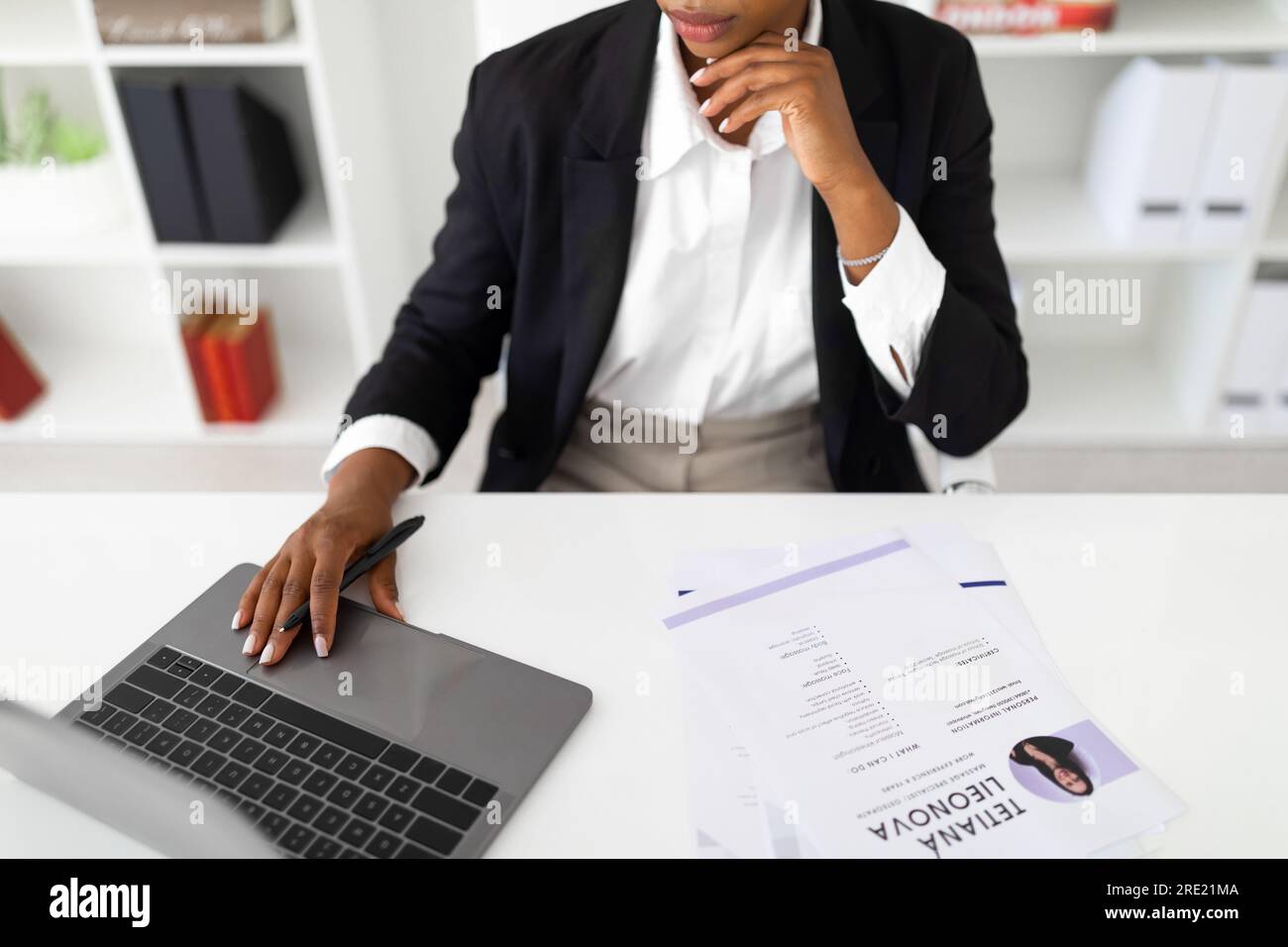Hr recruiter analyzing cv files - Hr Employee Looking At Cv Resume Of Candidates Analyzing Information Before Job Interview Sitting At Desk With Laptop 2RE21MA