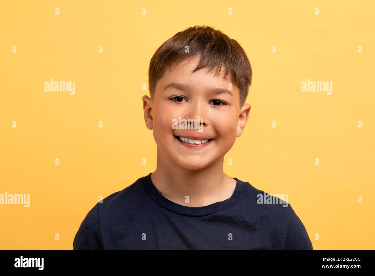 Funny cute preteen boy in black t-shirt smiling at camera Stock Photo ...