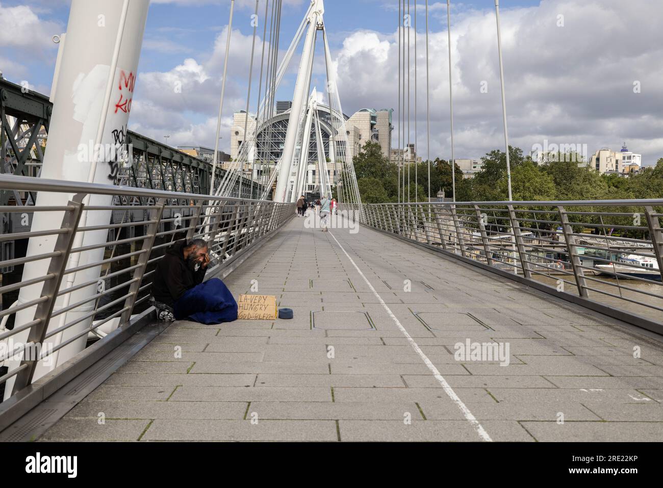 Homeless man begging for money on Hungerford Bridge, rough sleeping is soaring in London, with over 1,700 more people on the streets than last year. Stock Photo